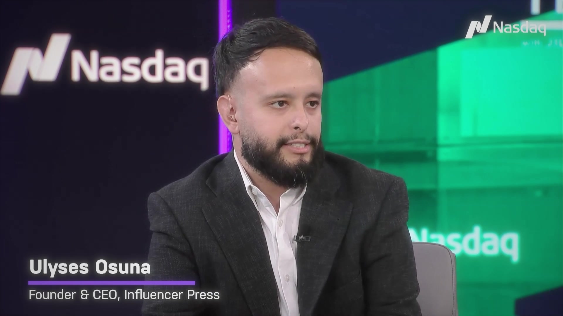 Ulyses in a dark blazer and open collar, lapel mic on, on the Nasdaq TradeTalks set; a lower-third reads Ulyses Osuna, Founder and CEO, Influencer Press.